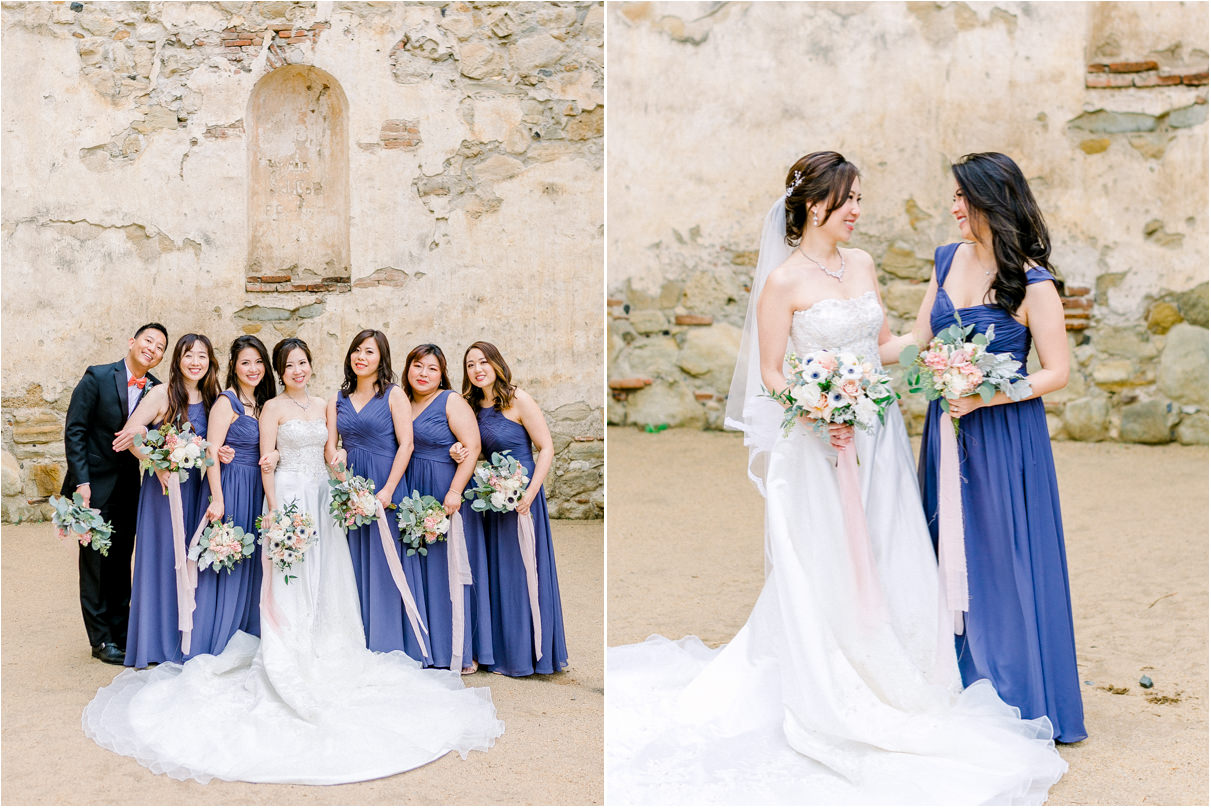 Bride with her bridesmaids in purple floor length dresses holding bouquets
