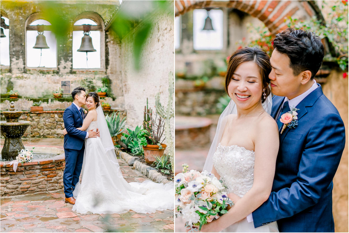 Wedding couple cuddling in courtyard at mission