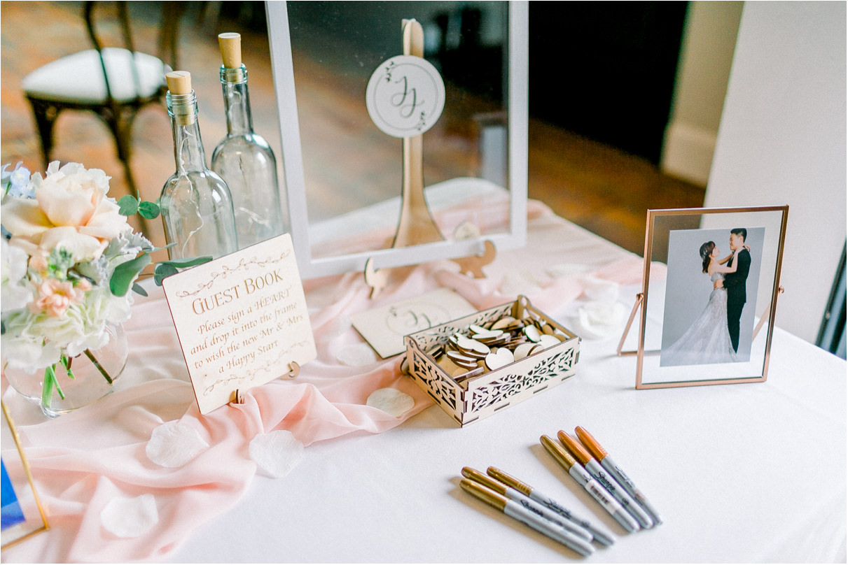 welcome sign in table at wedding with sharpies and pink linens