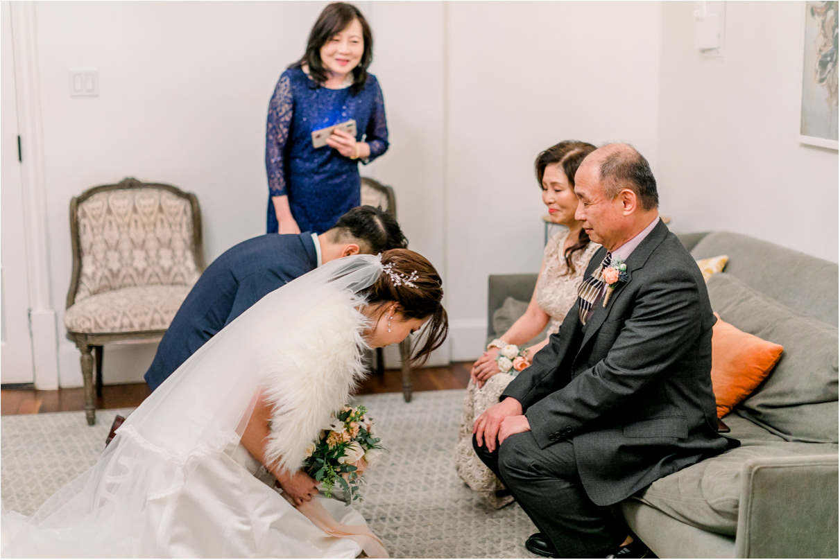 chinese tea ceremony where couple is bowing to brides parents