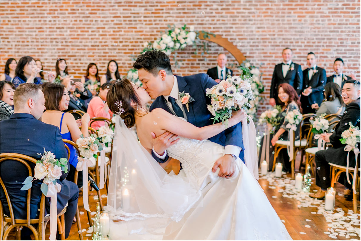 bride and groom kissing passionately at the end of the ceremony