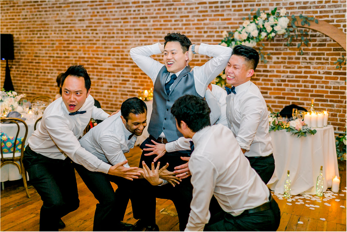 groom with groomsmen dancing around him