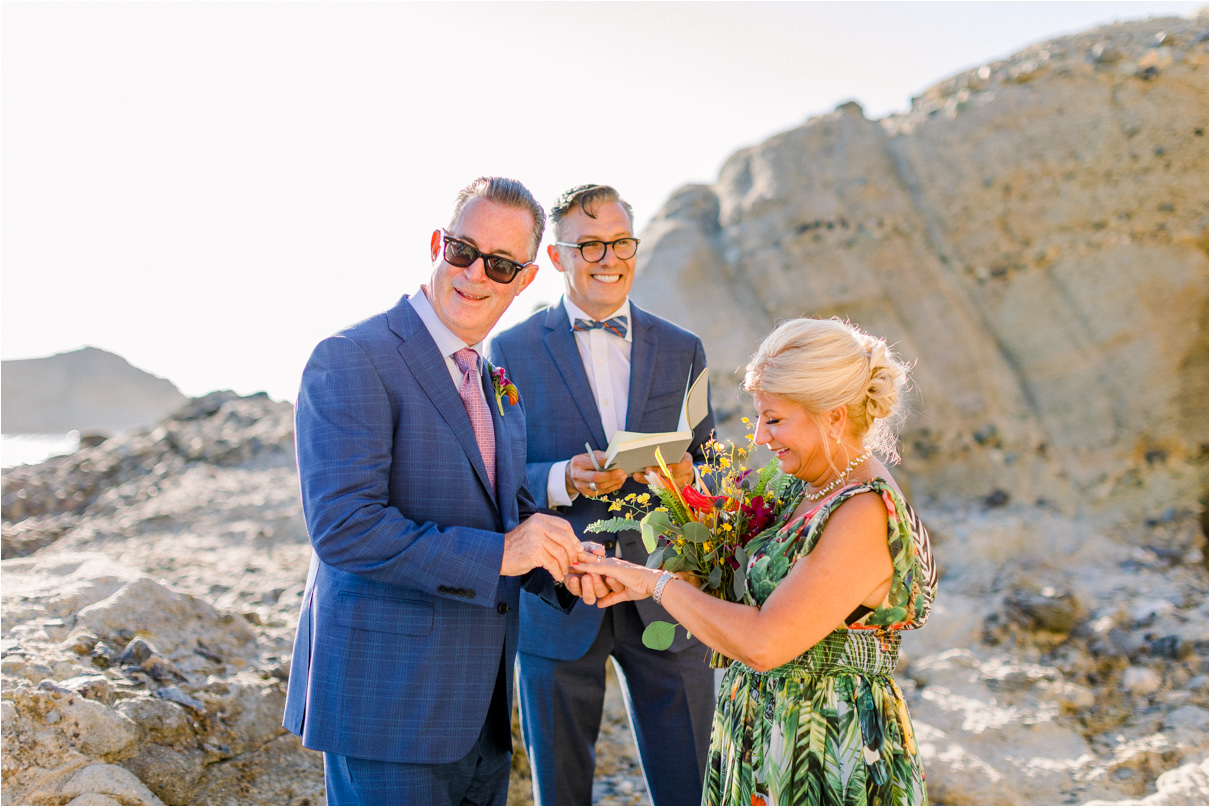 Man putting wedding ring on brides finger