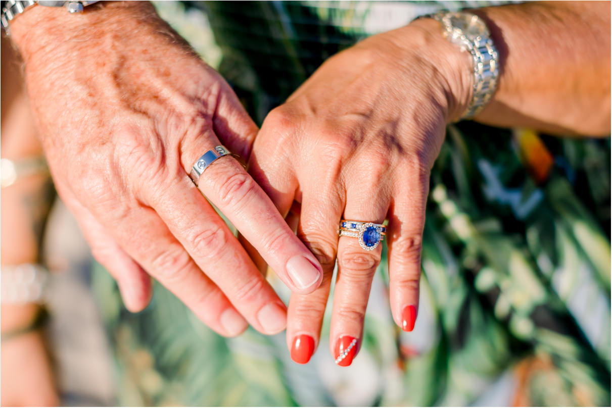 Man and woman showing their wedding rings to the camera