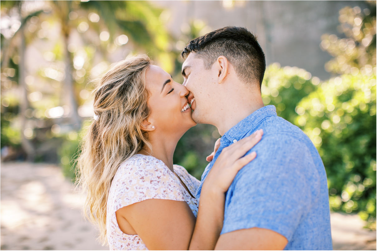 Couple smiling just about to kiss at beach