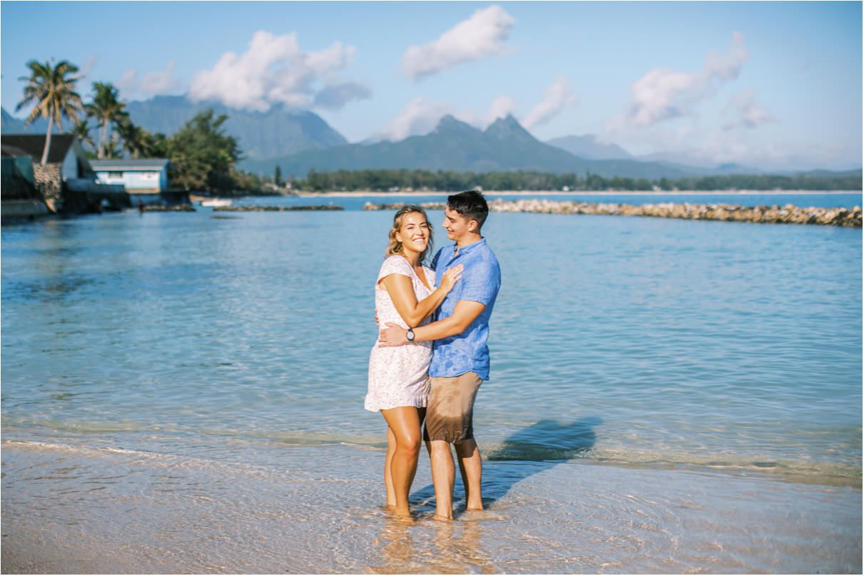 Couple posing at beach in hawaii wading in the water