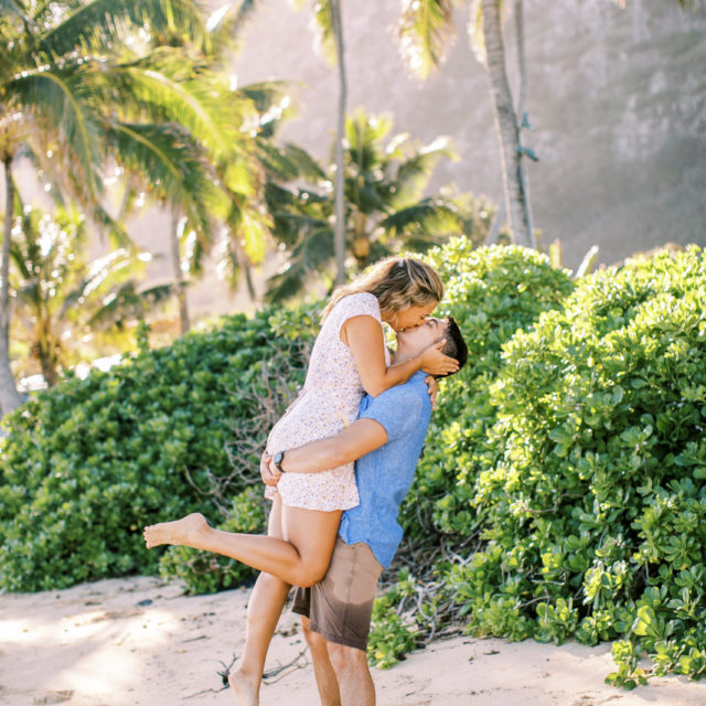 A couple kissing on Hawaii beach