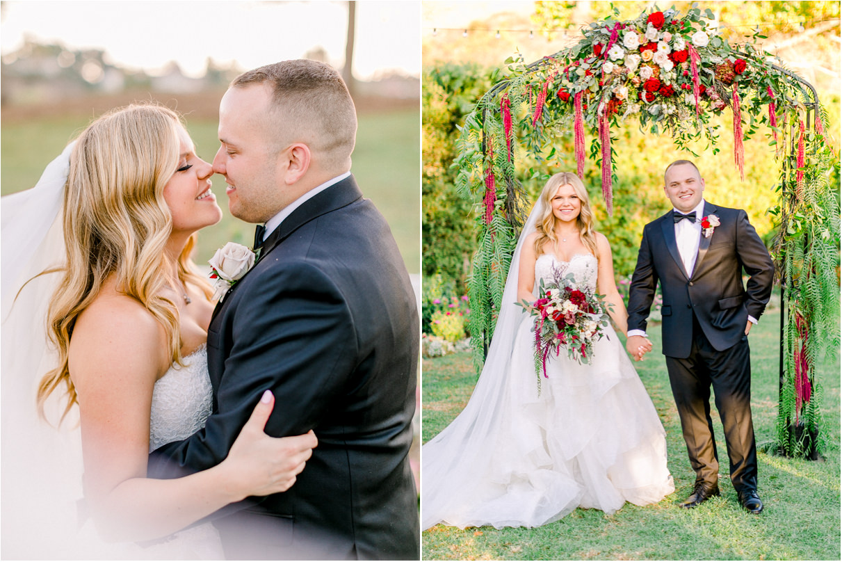 Bride and groom giving eskimo kisses and holding hands under wedding ceremony arch