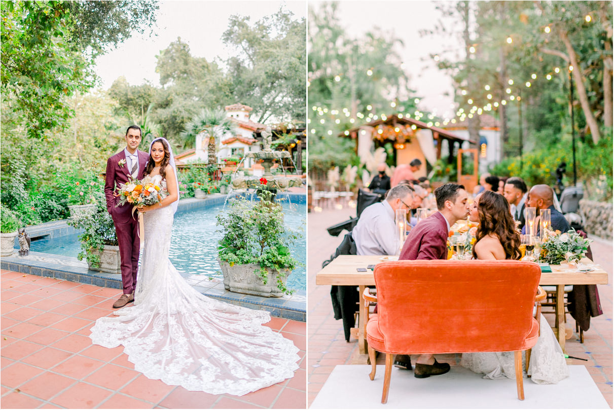 Bride and groom with long train sitting on orange velvet couch at wedding reception kissing