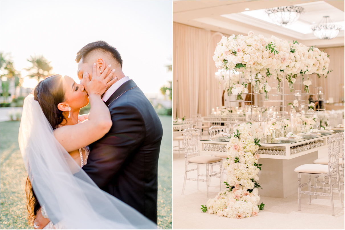 Bride and groom kissing at sunset and wedding reception table overflowing with white flowers