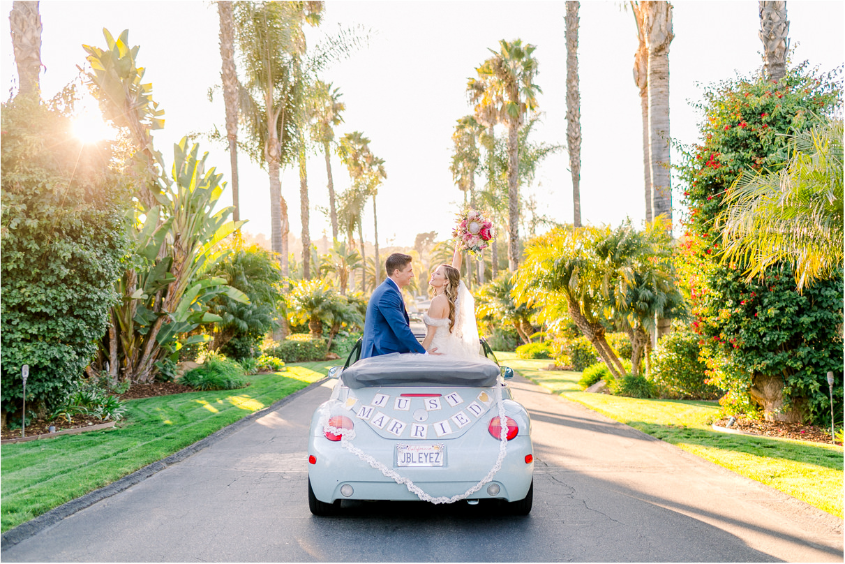 Bride and groom in getaway car with just married sign