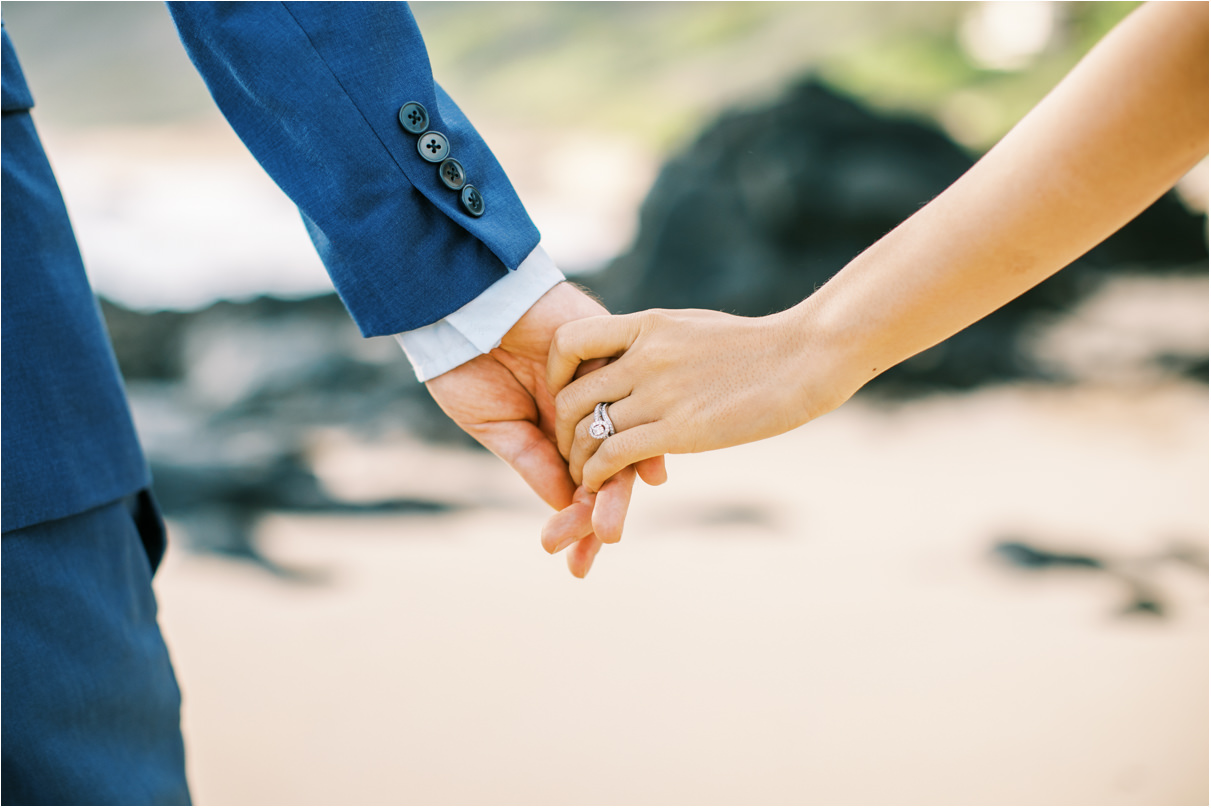 bride and groom holding hands closeup of wedding ring