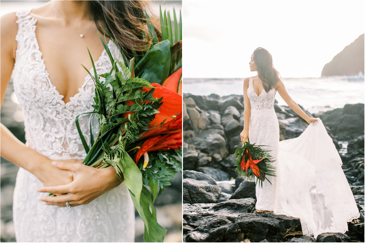 Bride on rocky beach holding wedding dress train and tropical bouquet