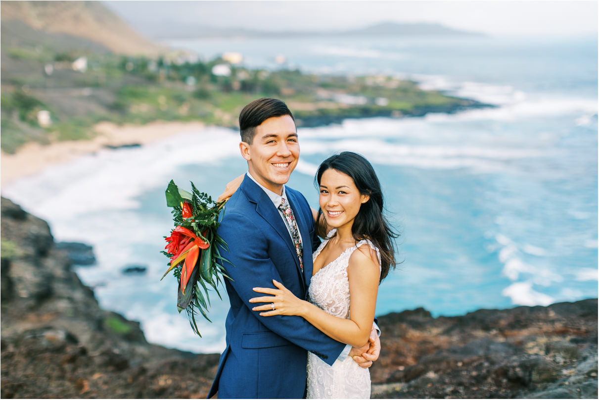 wedding couple smiling at beach lookout