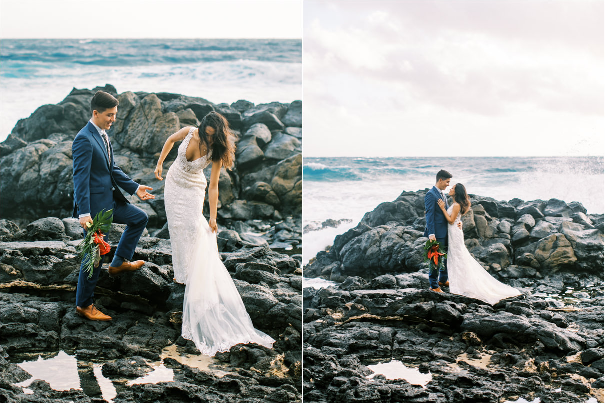 bride and groom on rocky beach with waves crashing behind them