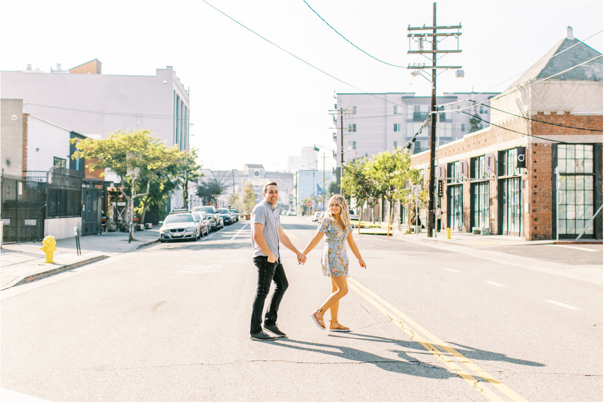 couple walking across street holding hands in Los Angeles