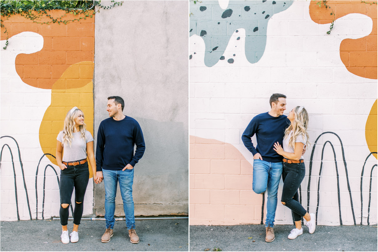 couple against mural wall in los angeles looking at each other