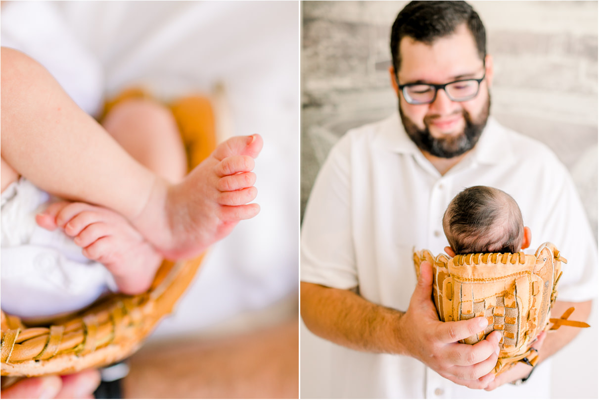 Dad holding newborn baby in a baseball glove