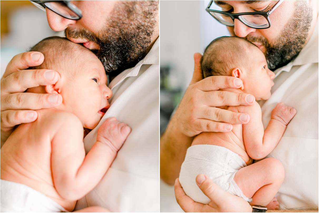 Dad is holding newborn baby on chest and kissing his forehead