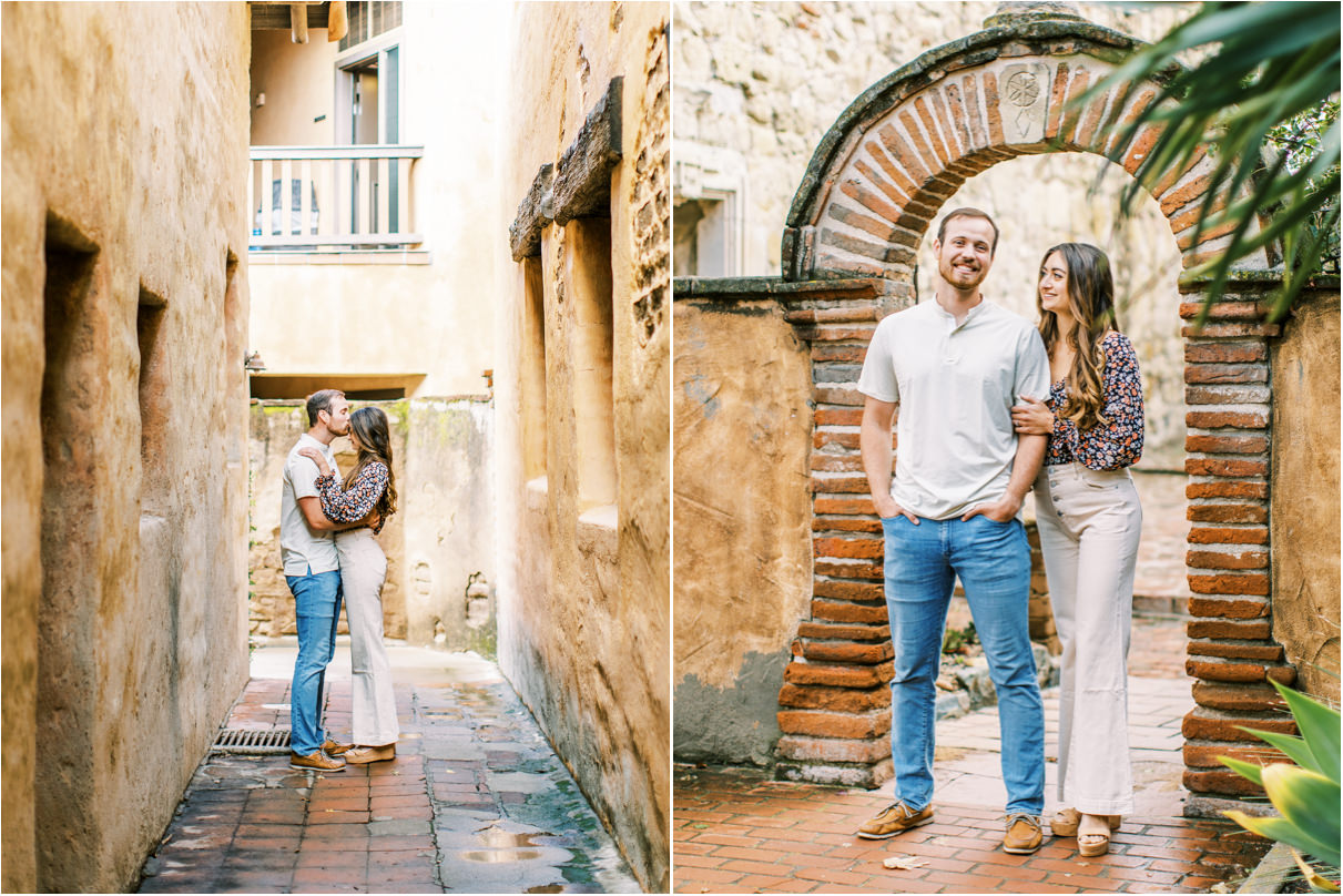 couple standing in long alleyway with man kissing womans forehead