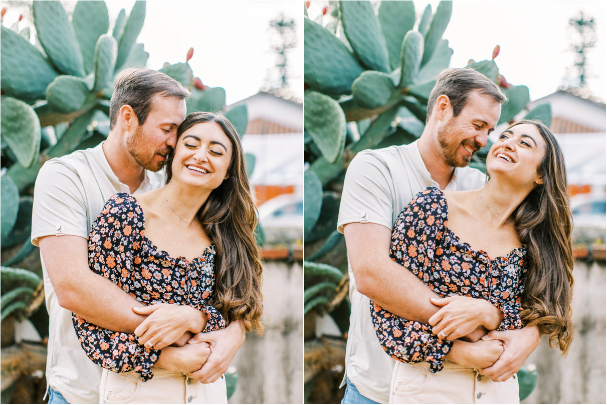 Couple smiling and lauging as man is hugging her from behind