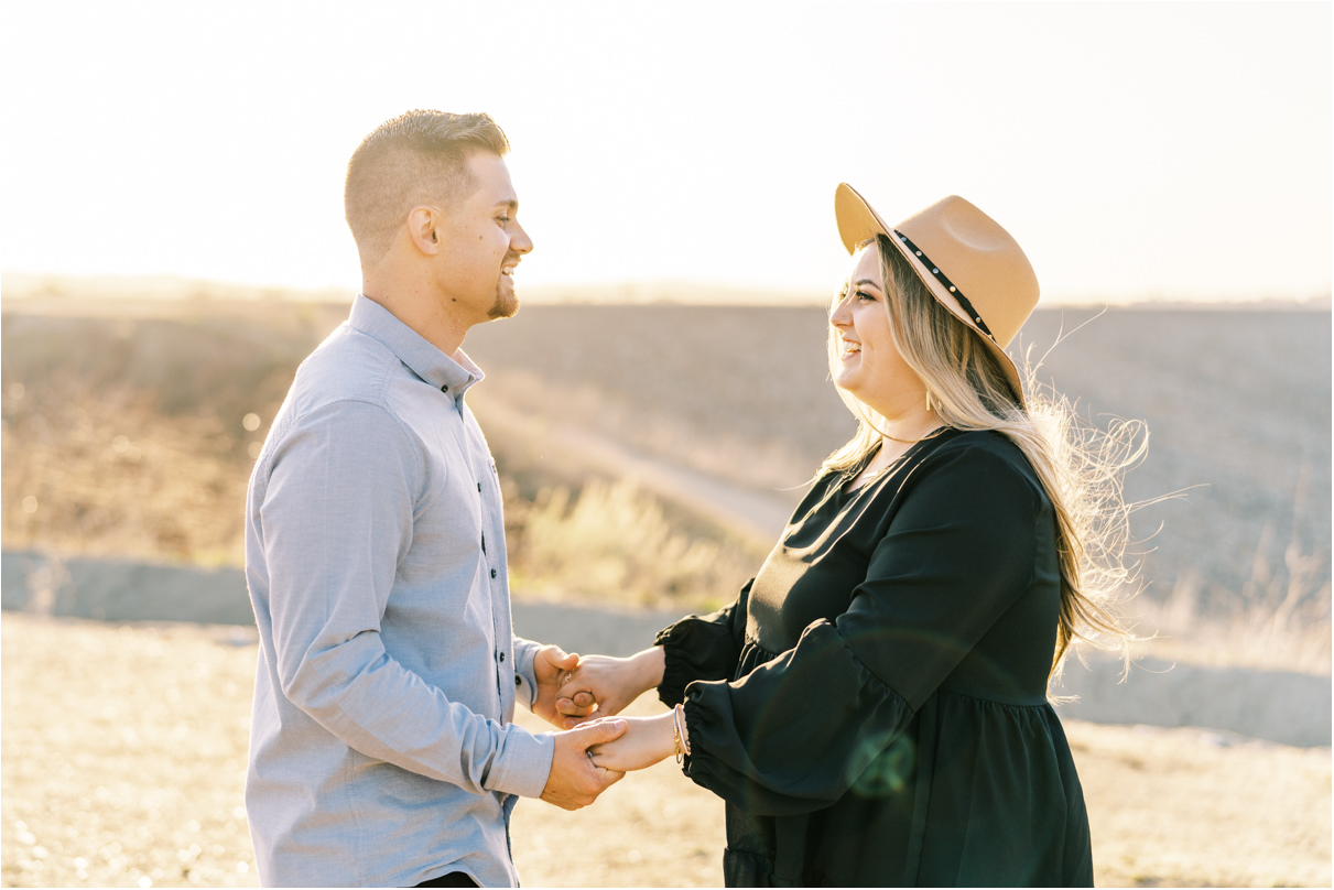 Couple holding hands and smiling at each other