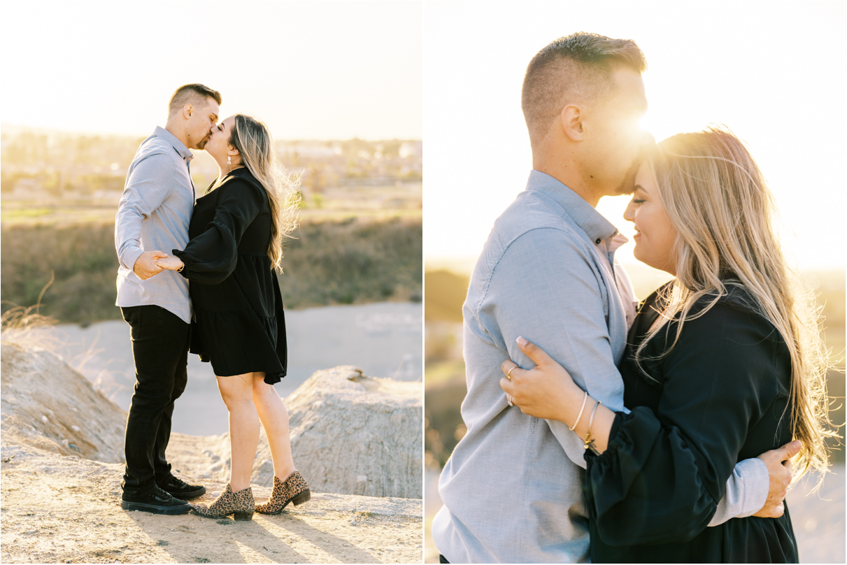 Couple kissing at sunset time with city scape behind them