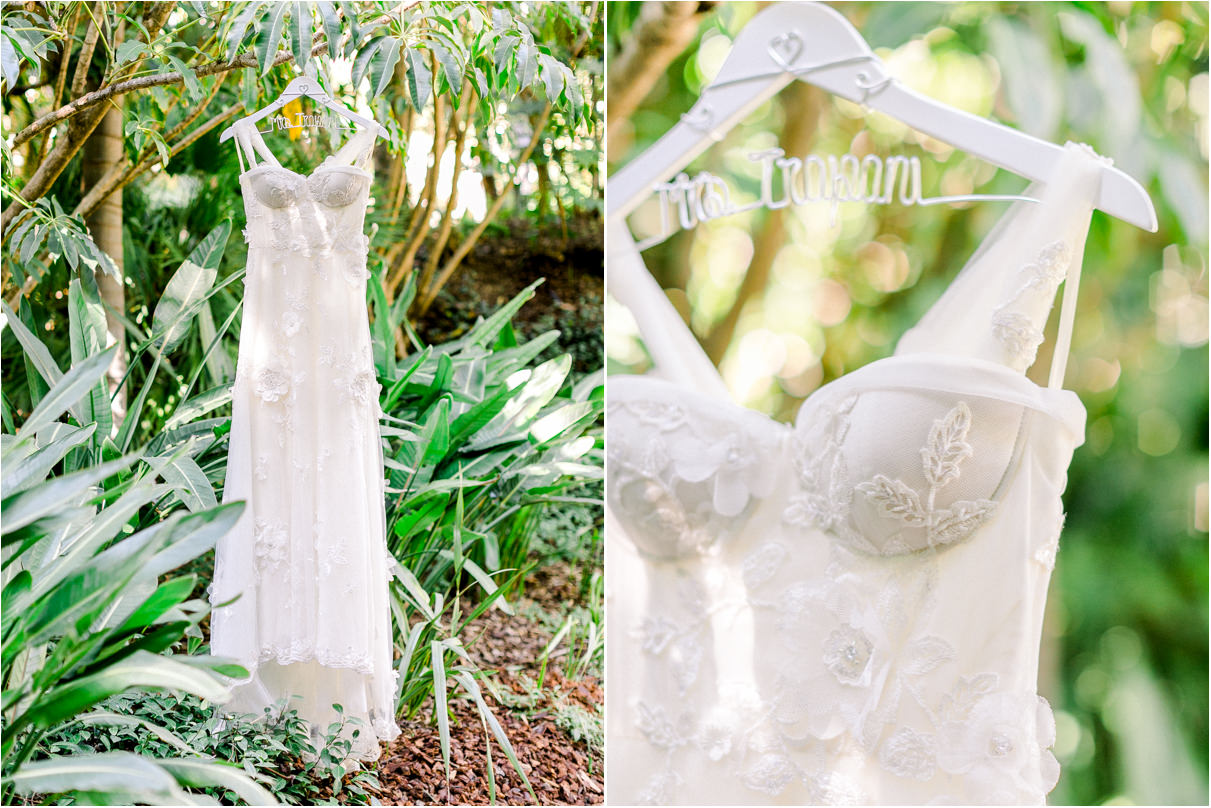 Wedding dress hanging in tropical garden with 3D flower appliques