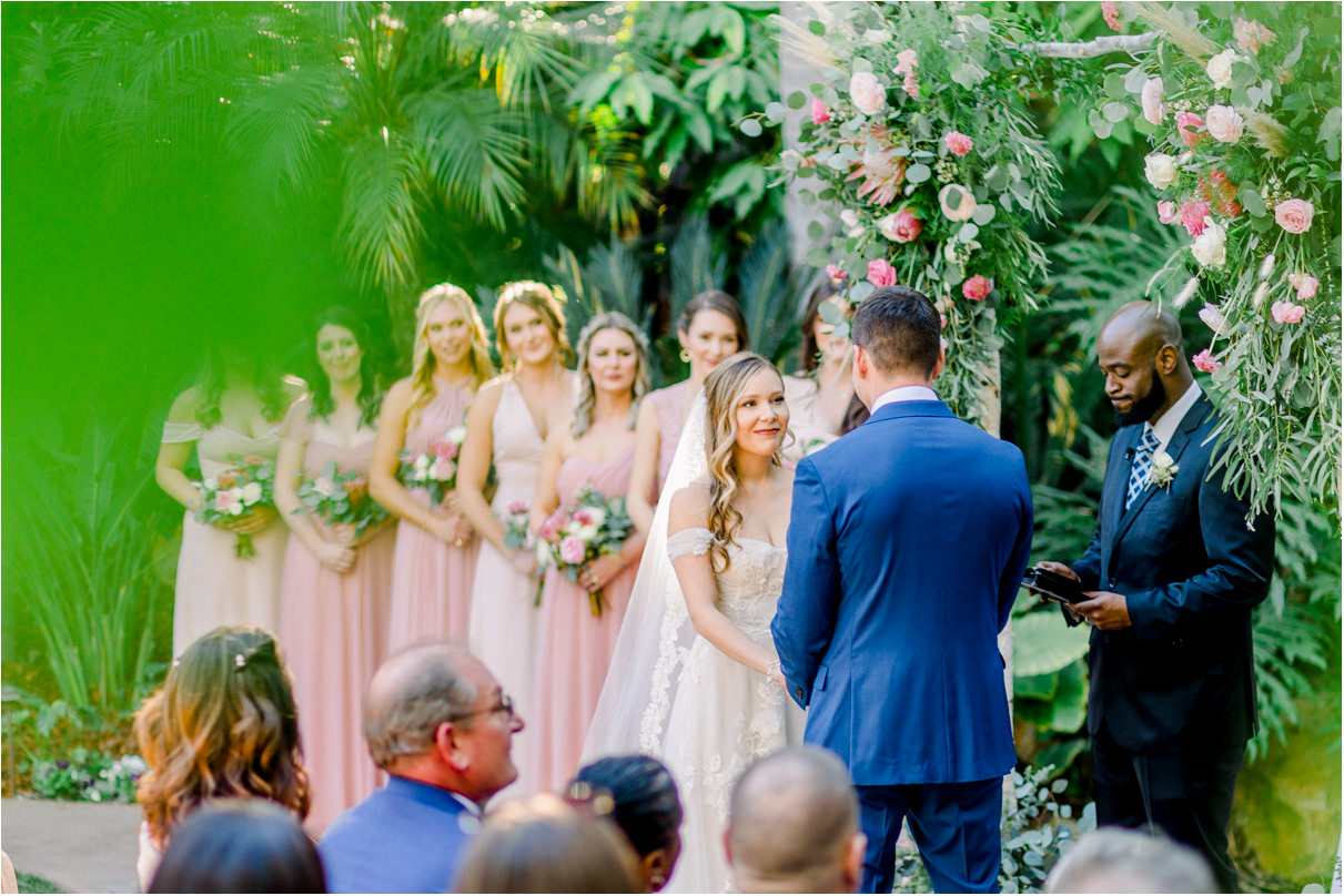 Bride with all her bridesmaids behind her during wedding ceremony