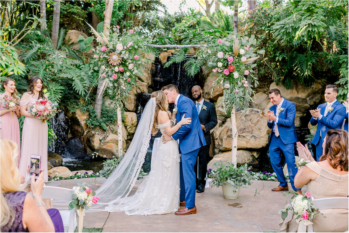 Wedding couple kissing at the end of san diego wedding ceremony