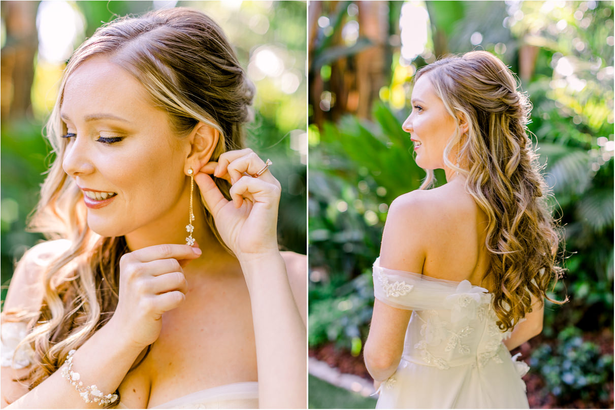 Bride smiling putting on dangle earrings with sunlight behind her