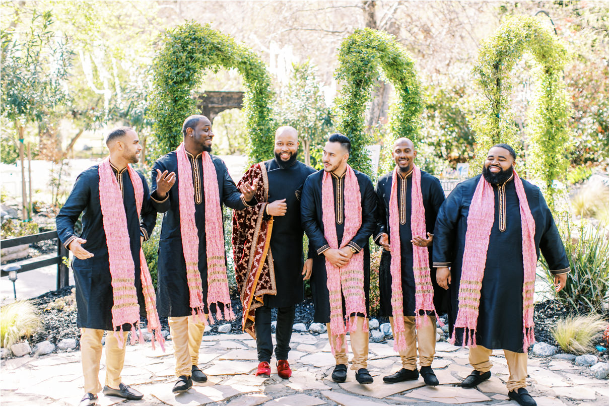 Group shot with groom and groomsmen walking and laughing