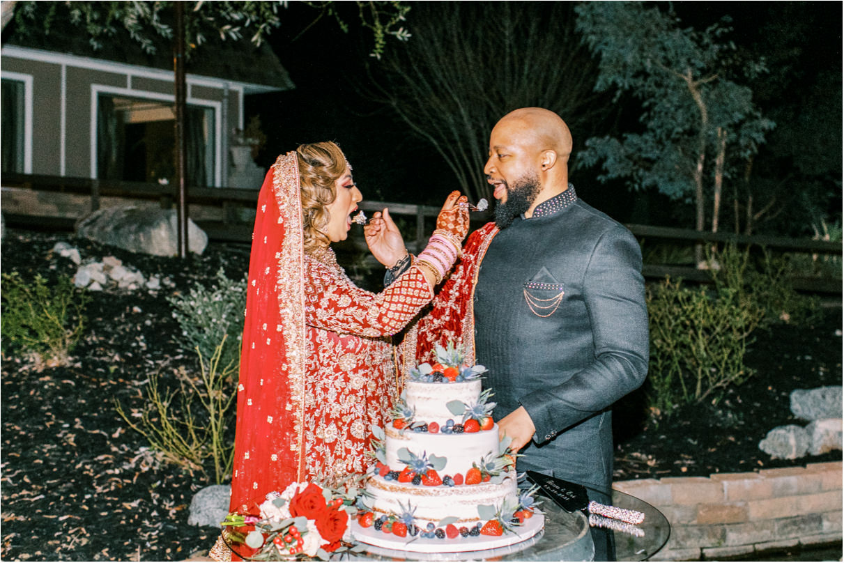 Bride and groom feeding each other wedding cake