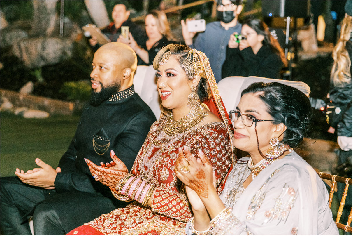 Wedding couple clapping during Pakistani dance performance
