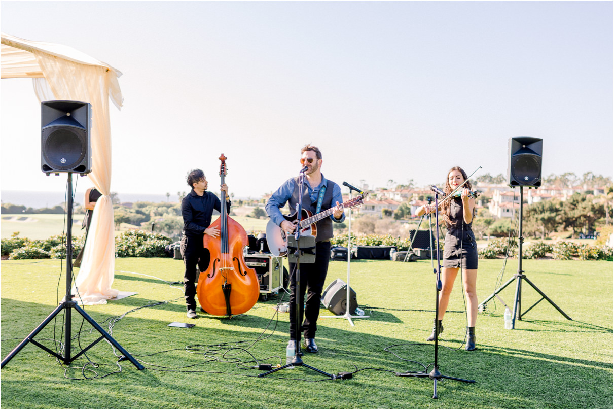 Band playing outside on lawn of Monarch Beach Resort for wedding ceremony