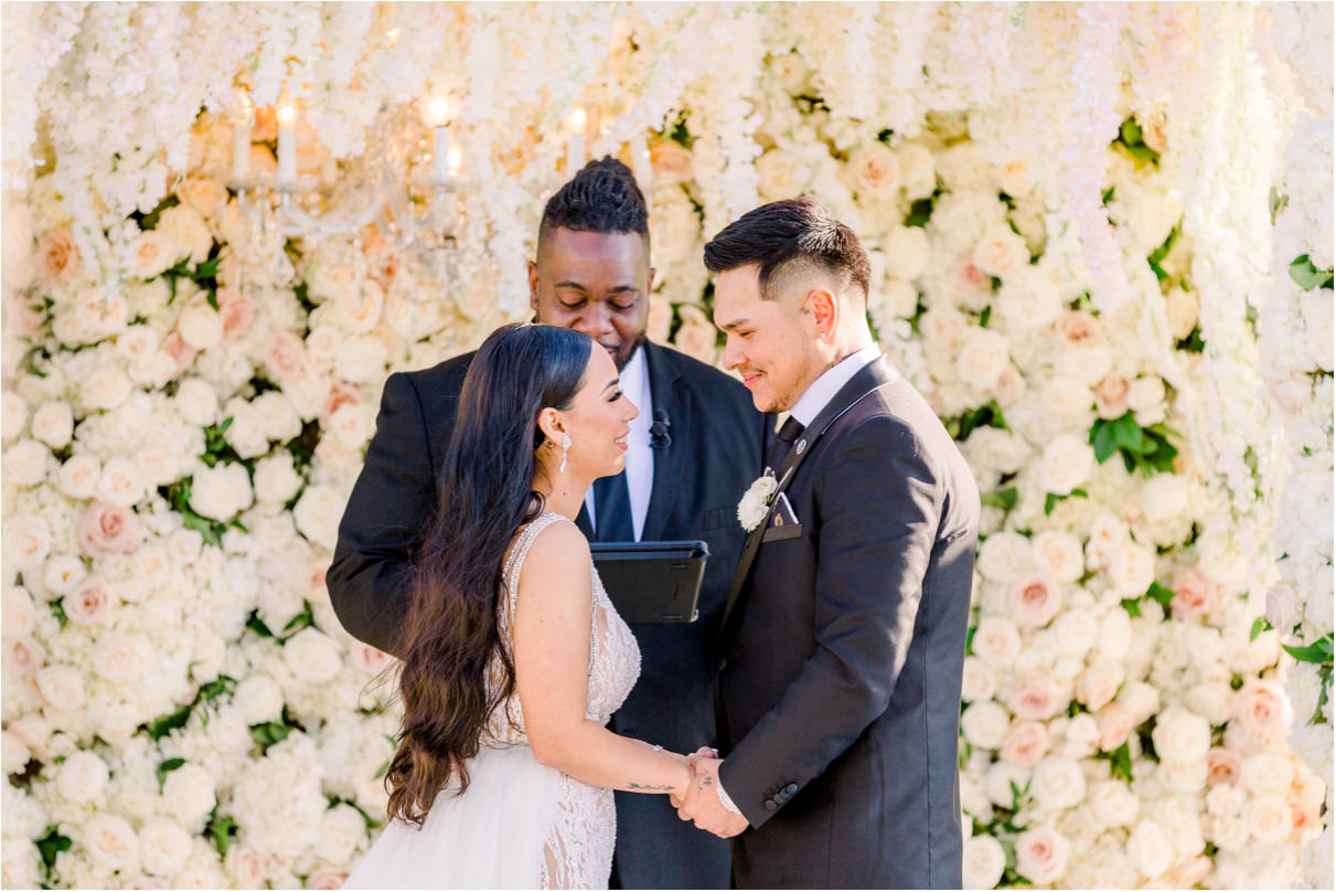 Bride and groom holding hands during wedding ceremony