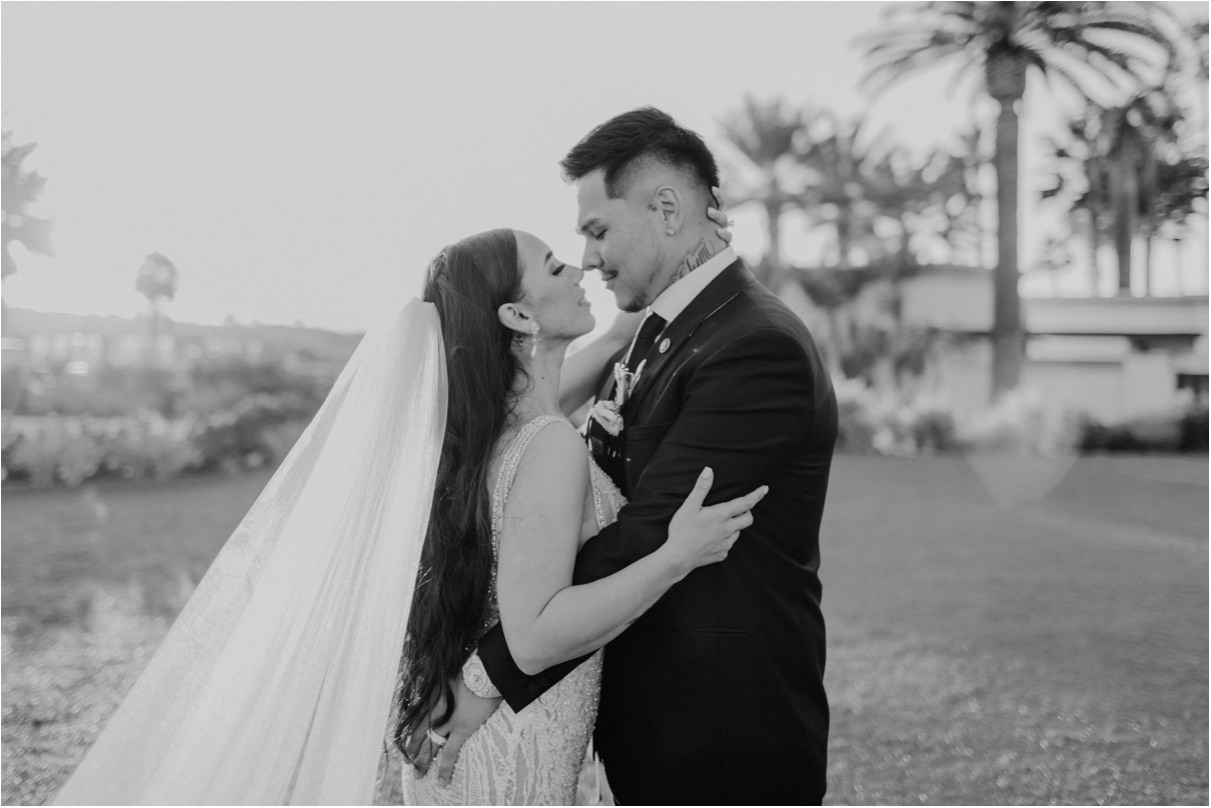 Black and white photo of couple holding each other looking into each others eyes