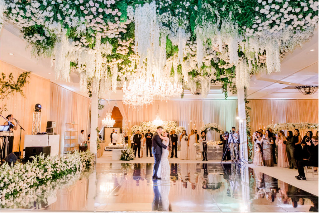 Bride and groom first dance under flower ceiling at Monarch Beach Resort