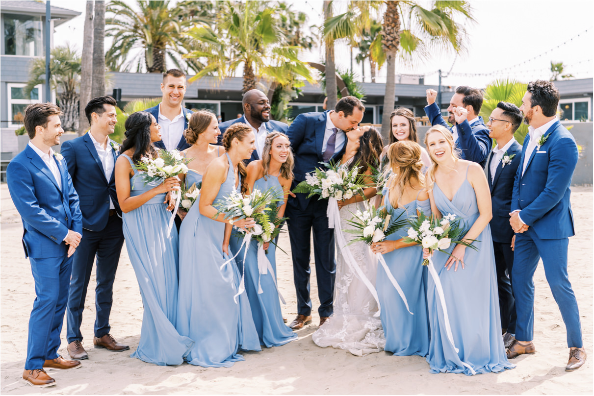 Wedding party on beach cheering