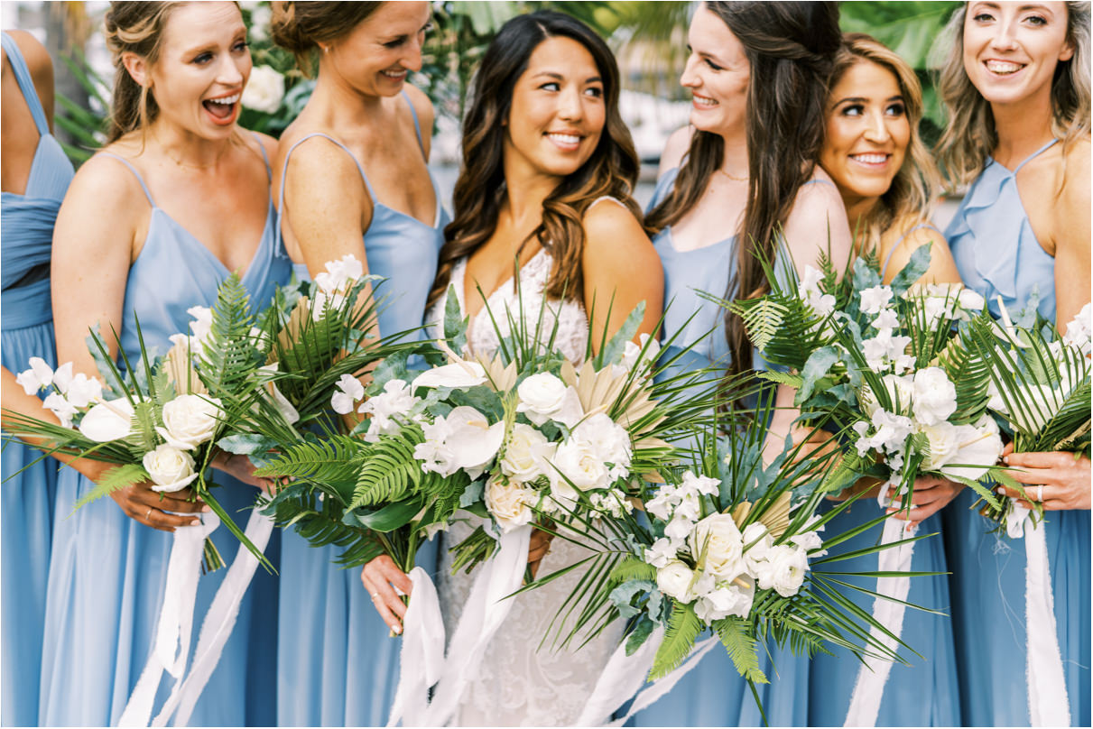 Bridesmaids holding tropical bouquets