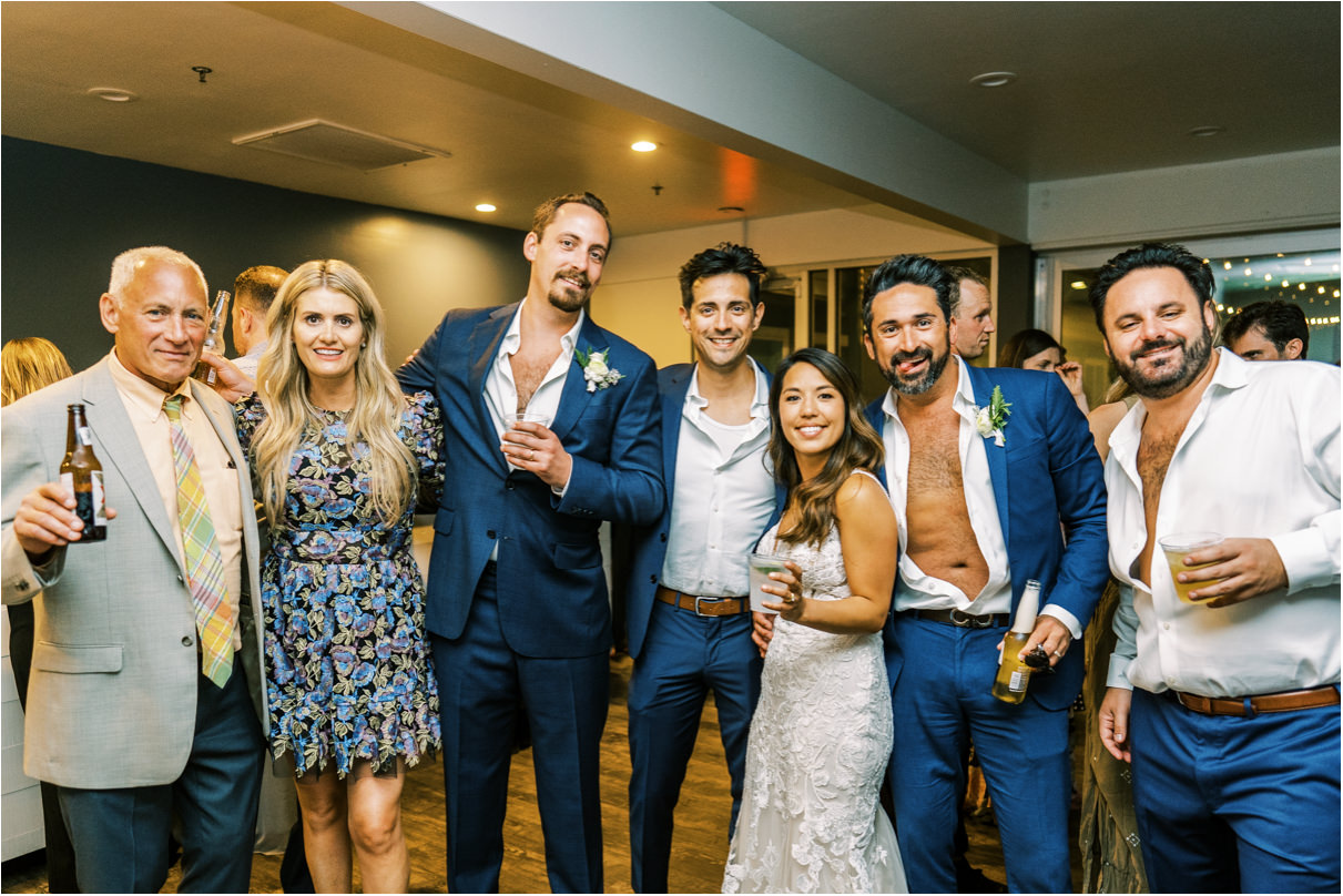Wedding reception group photo with guests holding drinks