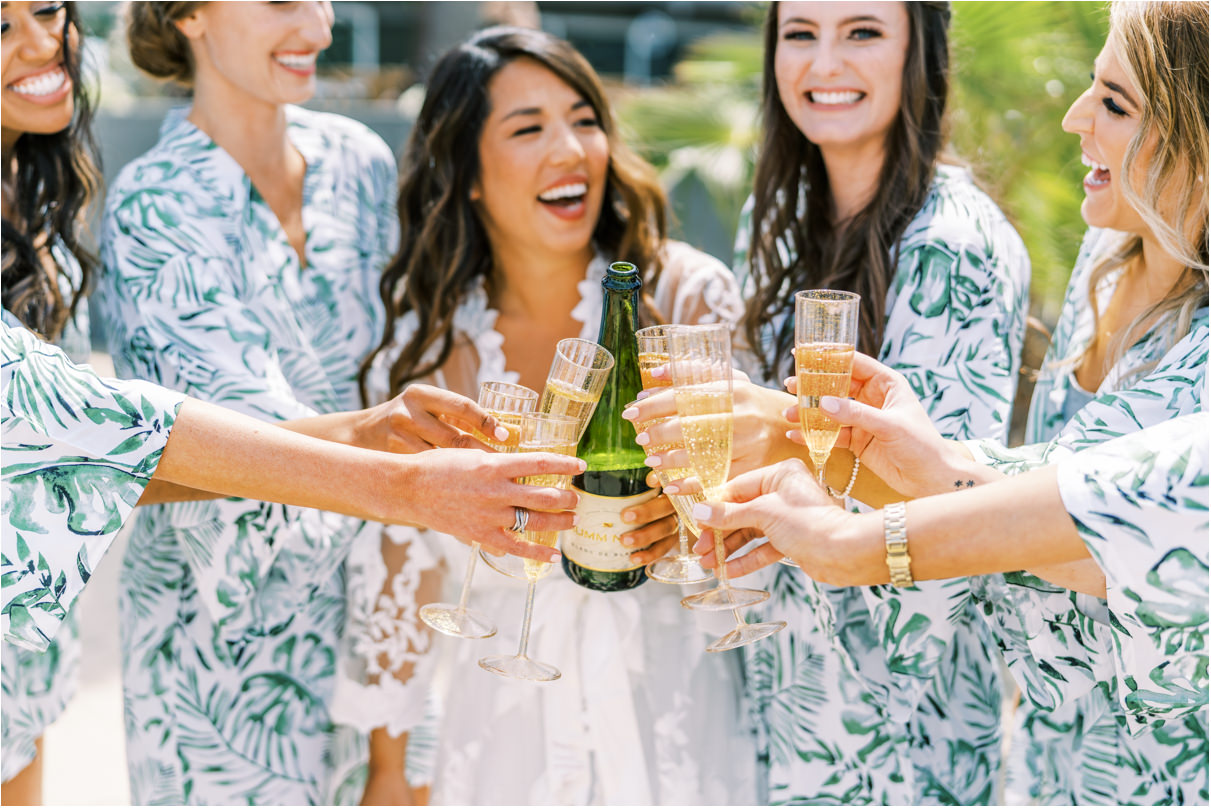 Bridesmaids cheer-ing with champagne