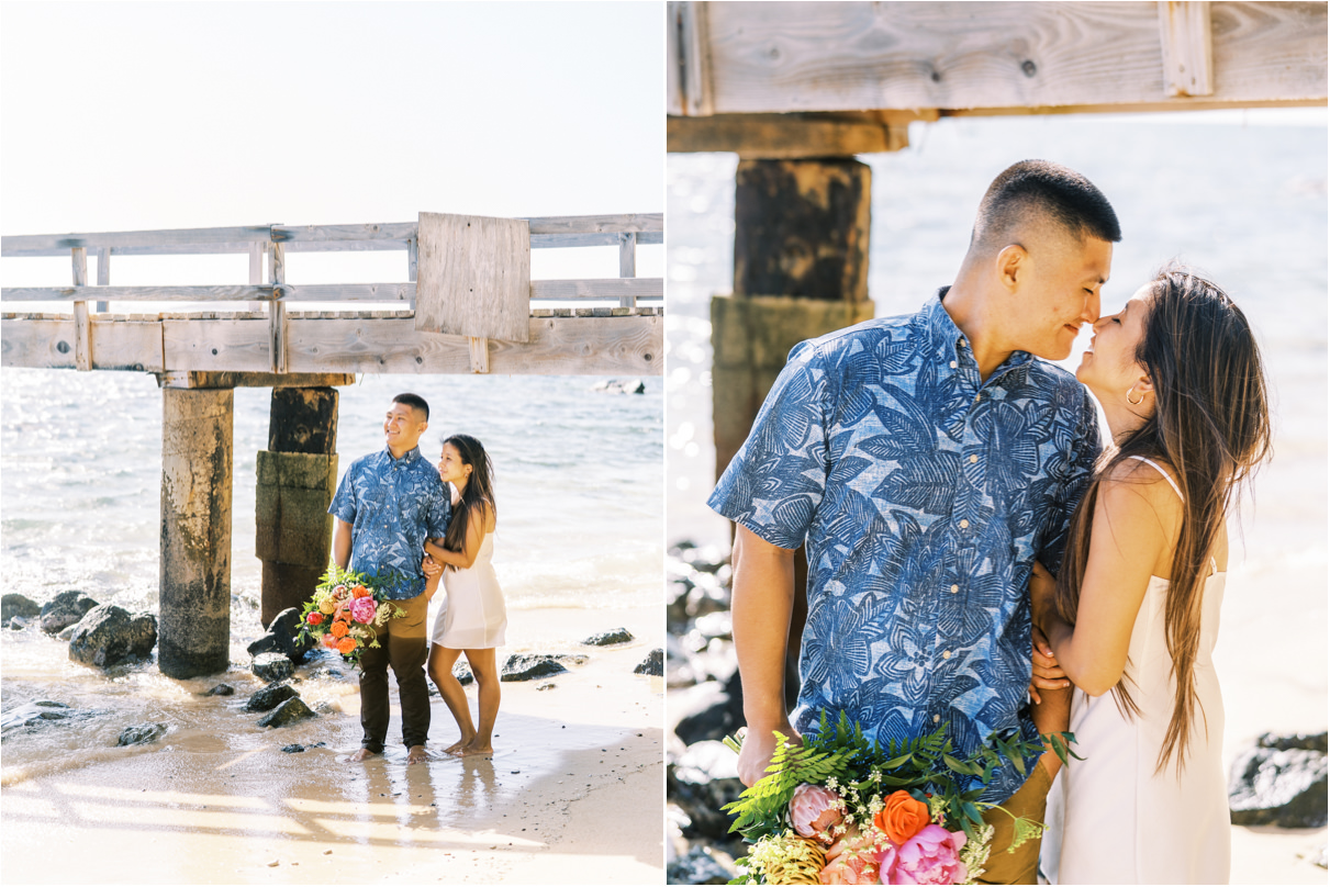 Couple standing near pier for engagement session in hawaii
