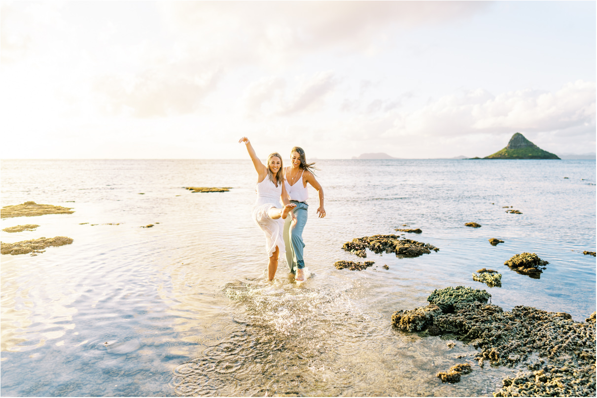 Beach Engagement Session lesbian couple in hawaii splashing water
