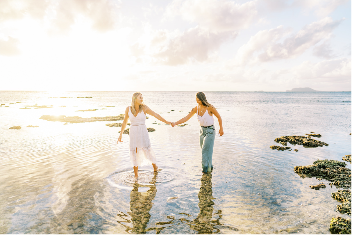 Beach Engagement Session lesbian couple in hawaii walking in low tide