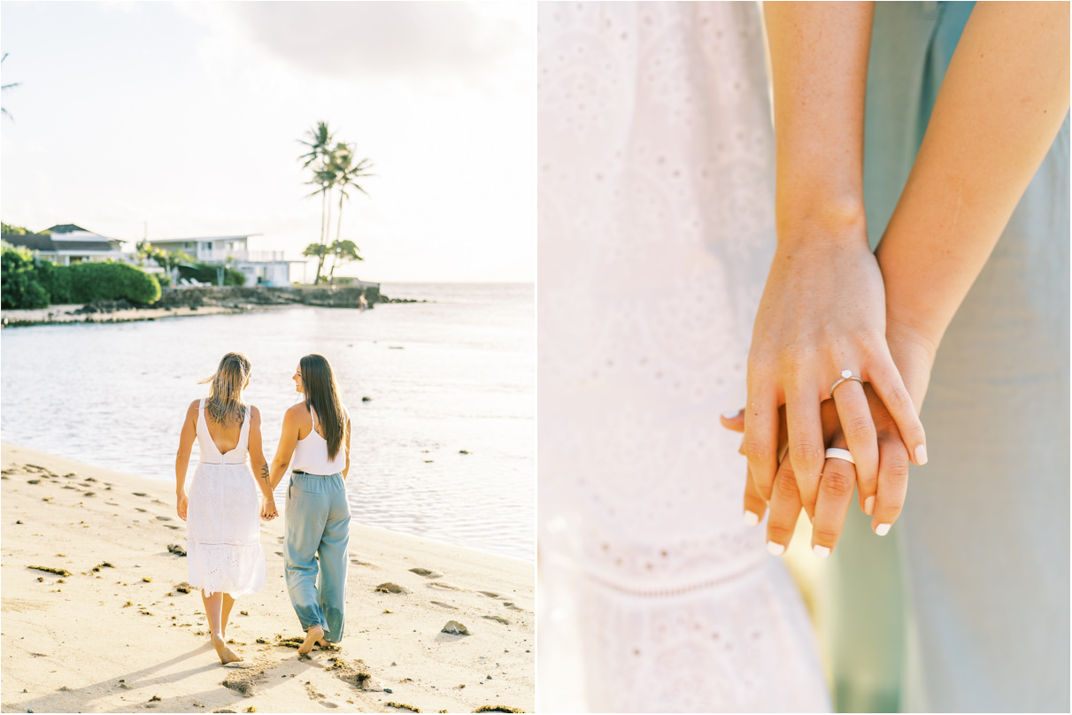 Lesbian couple in hawaii walking along beach holding hands