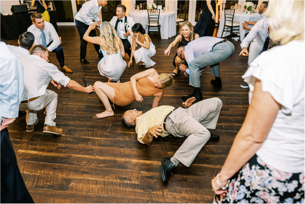 Wedding guests getting low while dancing on dance floor