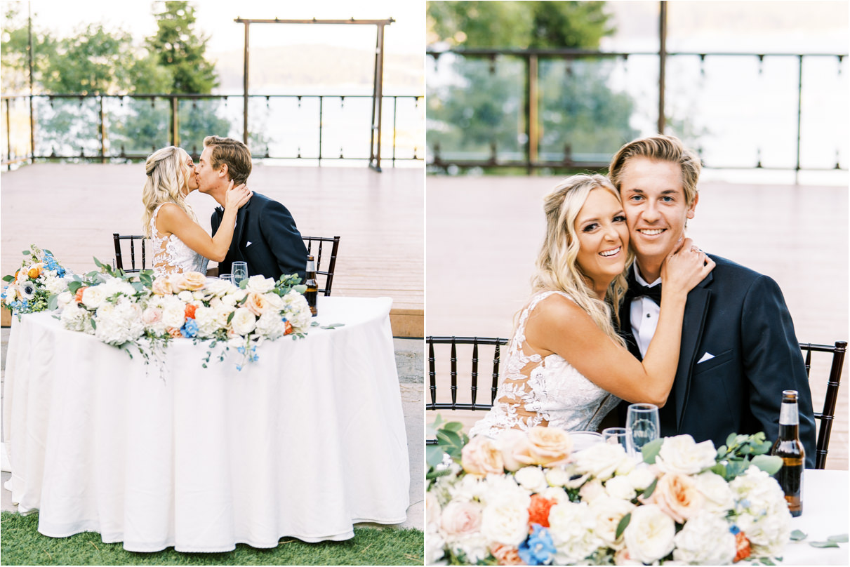 Bride and groom at wedding reception kissing at sweetheart table