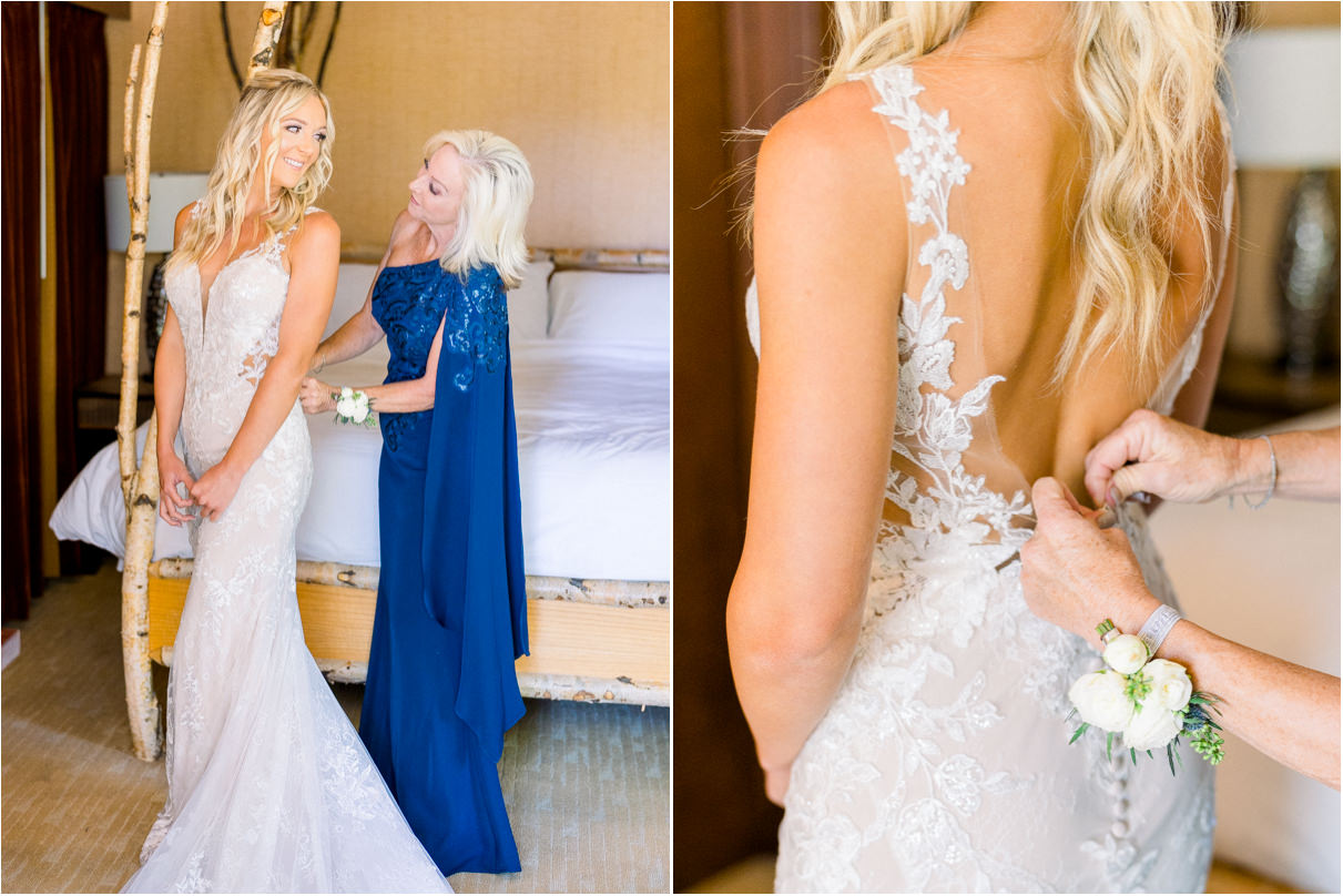 Mother of the bride zipping up brides dress in hotel room