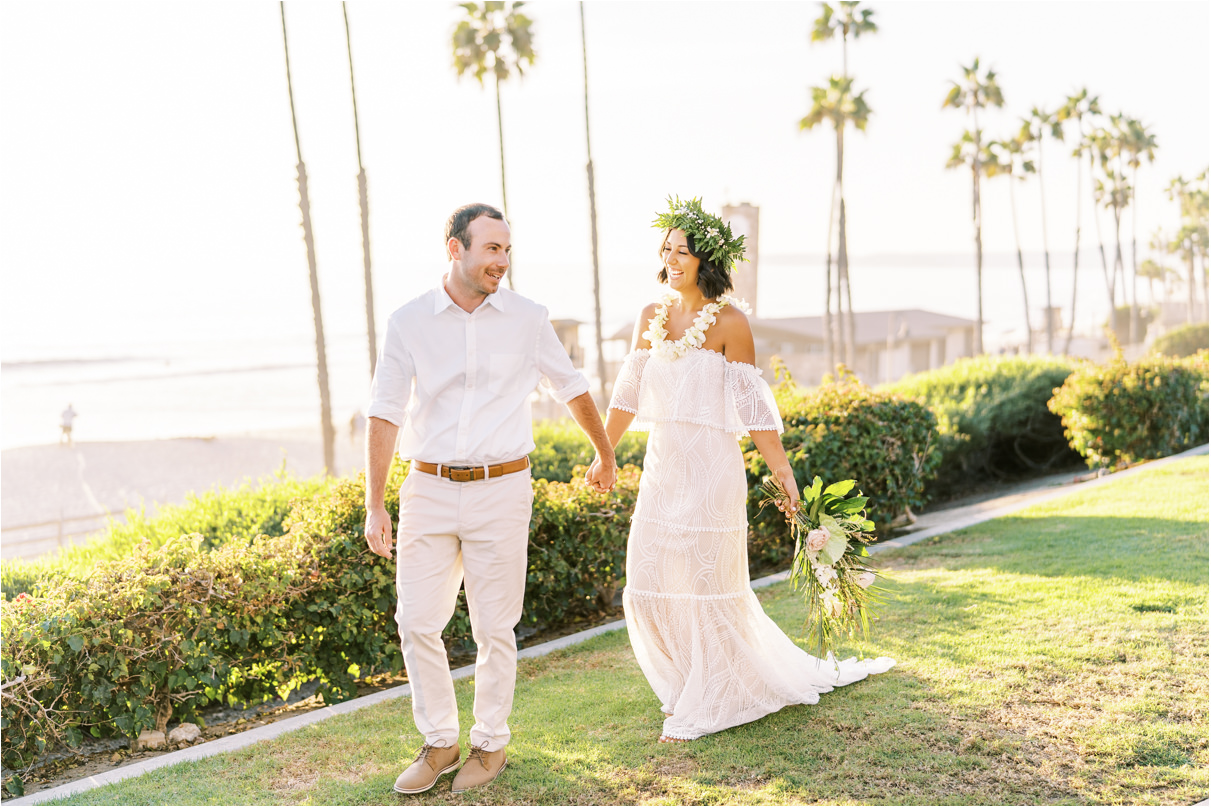 Bride and groom walking holding hands in San Clemente